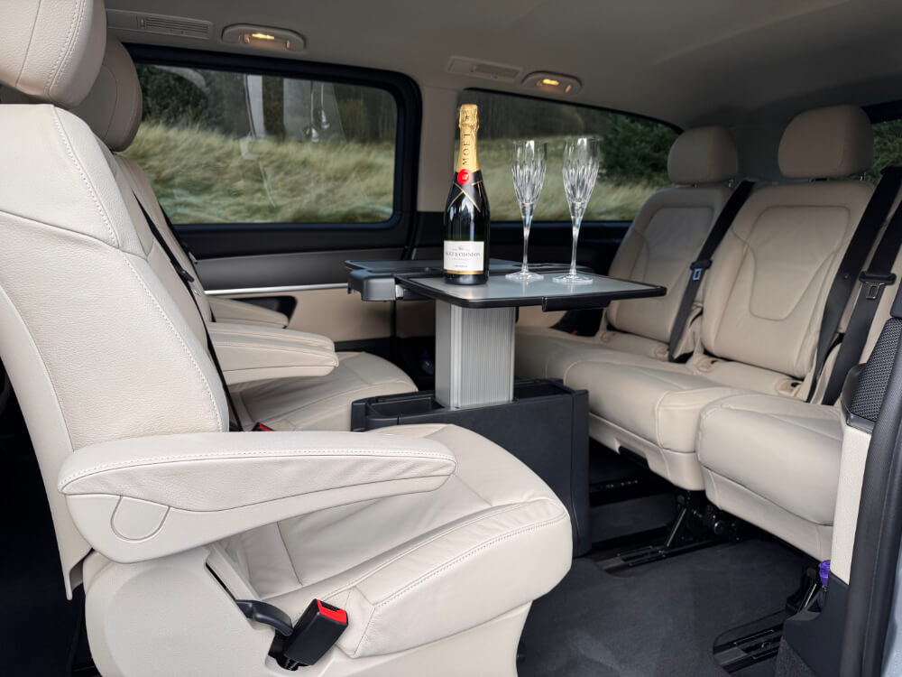 interior of car with champagne on table